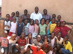 Tonny and the children who received the donated rice in Kampala Uganda Africa