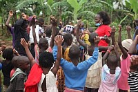 Founder Tonny Mwesigwa’s Wife Praying for the Children Before the Food Was Given to 100 Children in Kampala, Uganda