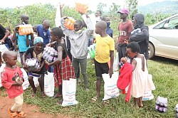 Children of Kampala Uganda holding their gifts of rice and soda pop