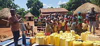 Everyone looks on as Tonny Mwesigwa dedicates well 60 near Kampala, Uganda