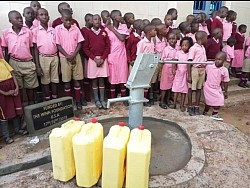 Beautiful children in maroon and pink at the new well. Near Kampala, Uganda